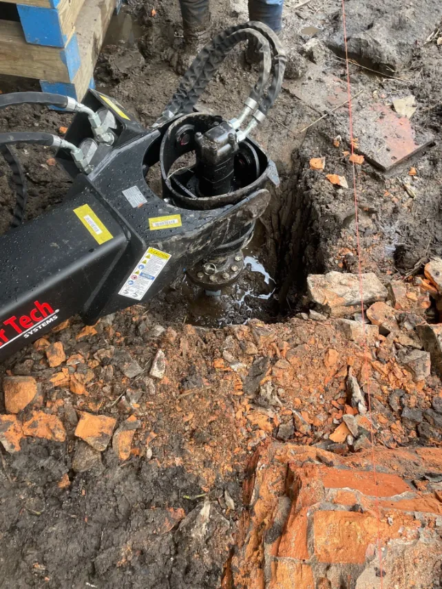 Helical piling being installed under a residential property in North Carolina (project 7)