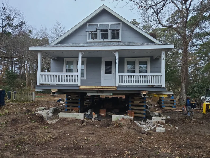 A house currently being lifted for a new foundation