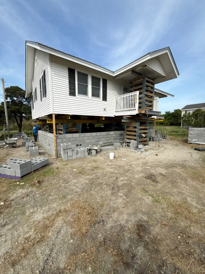 A house currently being lifted for a new foundation angle 3
