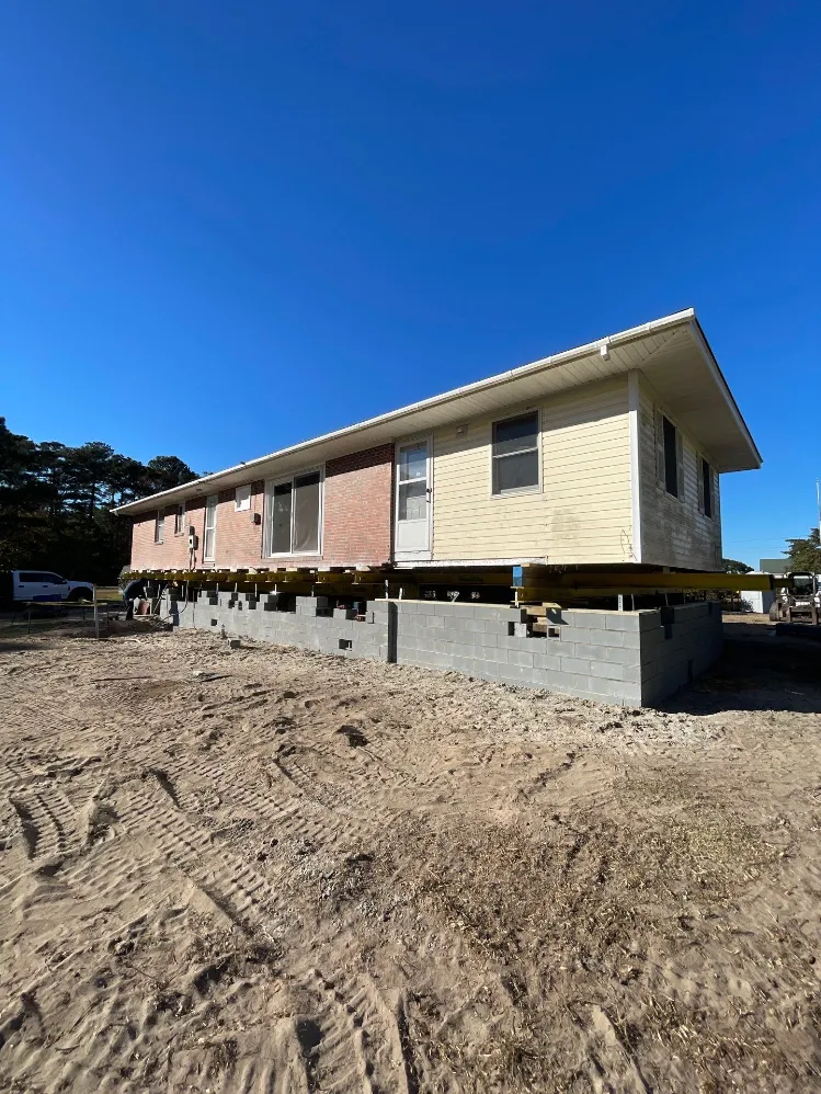 A house currently being lifted so that a new foundation can be built angle 3